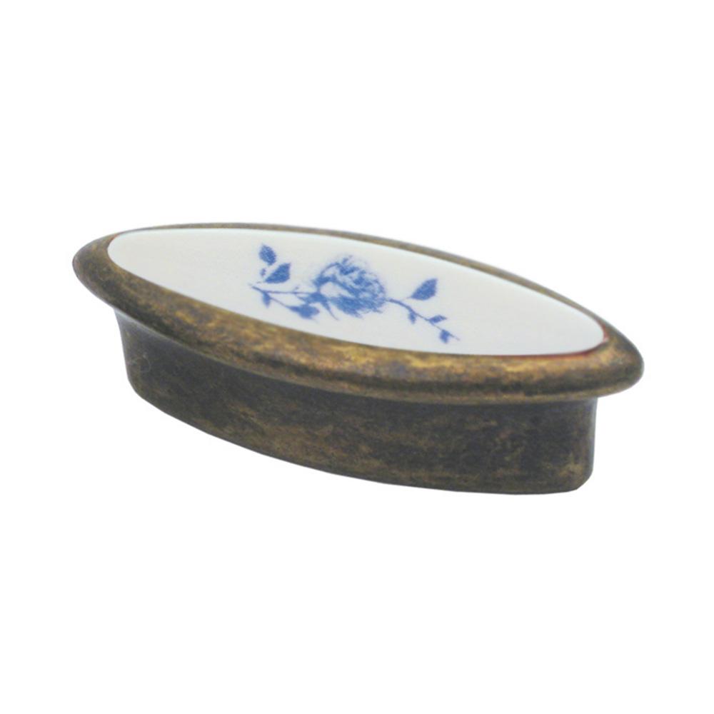 Oval-shaped solid brass knob with a porcelain center and painted rose detail.